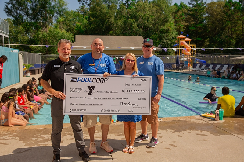 Poolcorp presenting a check to the YMCA