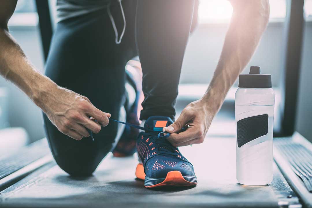 man tying running shoes